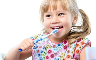 young girl brushing her teeth 