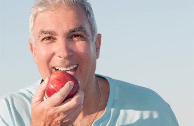 Man biting apple