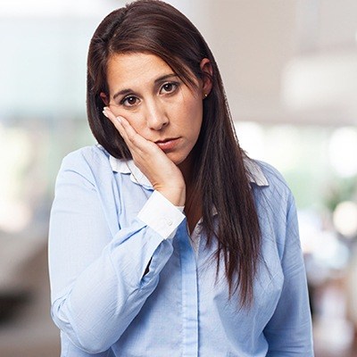 Woman with toothache holding jaw