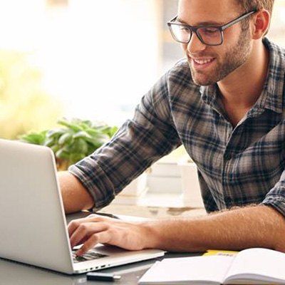 Man smiling at laptop