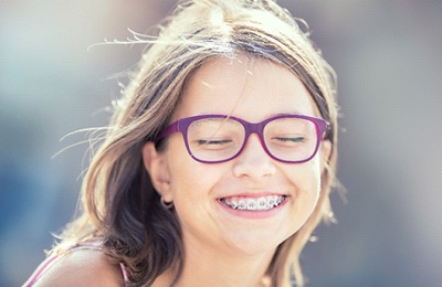 A young girl with braces.