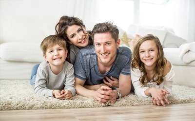family posing on the carpet 