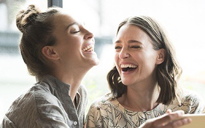 Two women laughing together