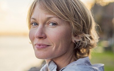 Older woman smiling at beach