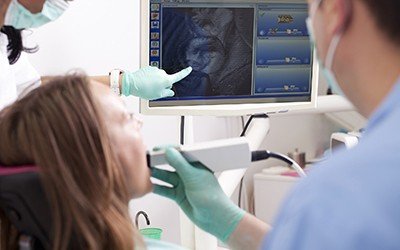 Dentist and patient looking at intraoral photos