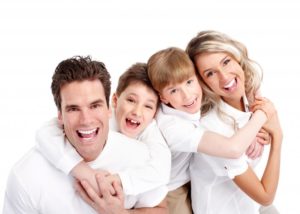 family smiling for photo